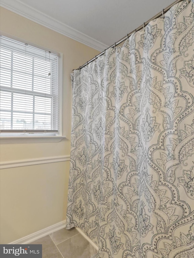 bathroom with tile patterned floors, a shower with curtain, and ornamental molding