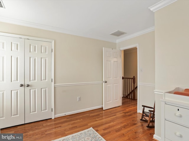 sitting room featuring wood-type flooring and ornamental molding