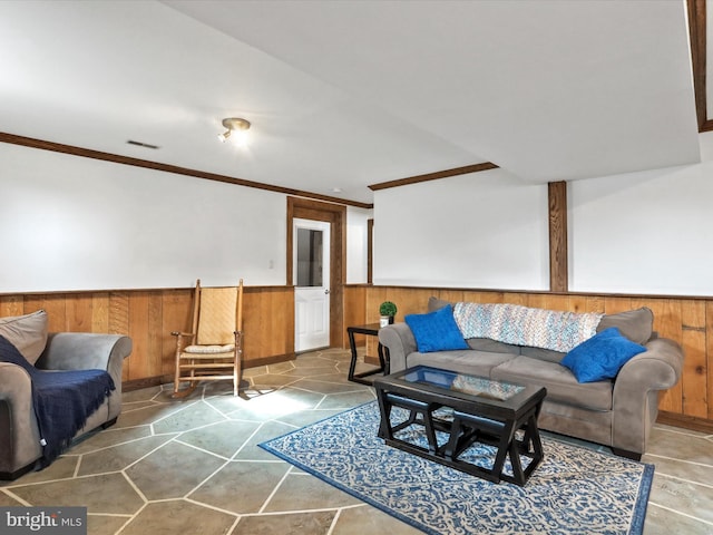 living room with crown molding and wood walls