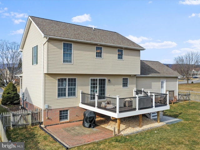 rear view of property featuring a yard and a wooden deck