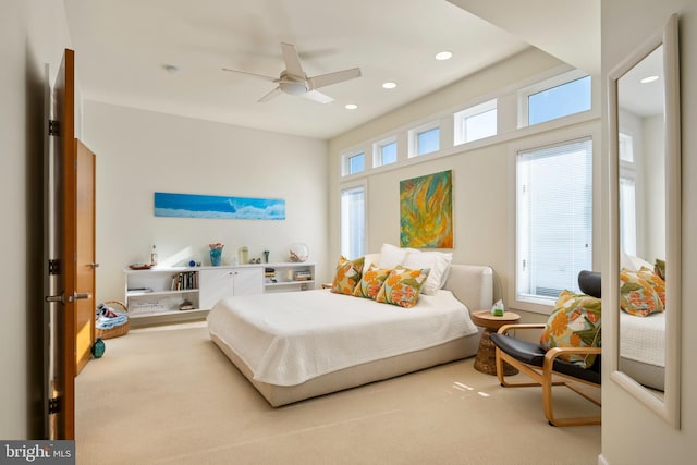 bedroom with ceiling fan, carpet floors, and multiple windows