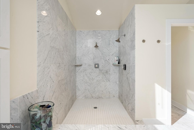 bathroom with a tile shower