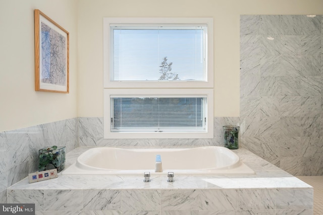 bathroom with a relaxing tiled tub