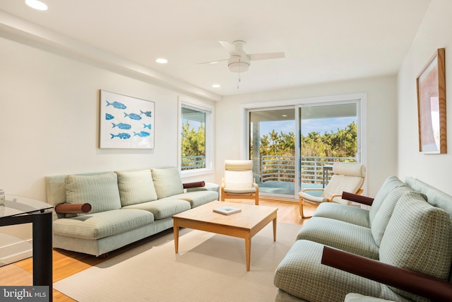 living room with plenty of natural light, ceiling fan, and light hardwood / wood-style floors