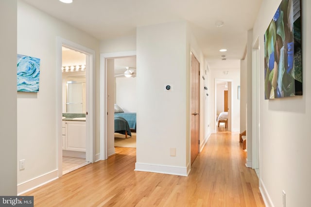 hallway with light hardwood / wood-style flooring