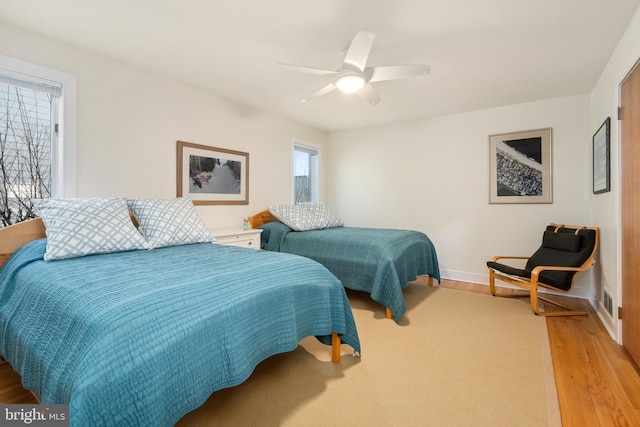 bedroom with ceiling fan and light hardwood / wood-style floors