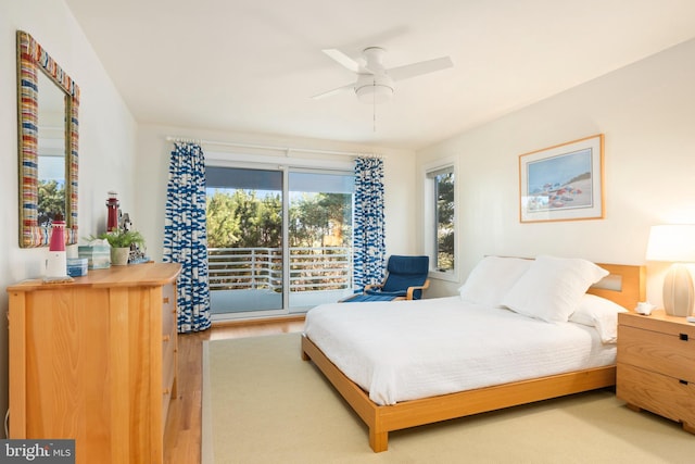 bedroom featuring ceiling fan, hardwood / wood-style floors, and access to outside