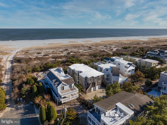 birds eye view of property featuring a water view and a view of the beach