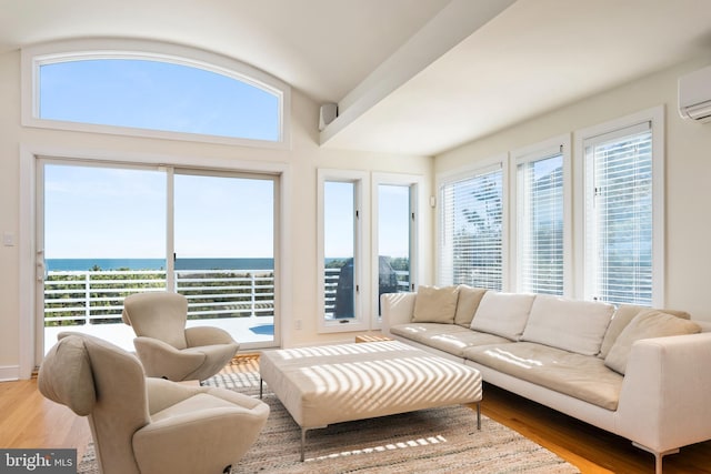 interior space with a healthy amount of sunlight, a water view, and a wall mounted AC