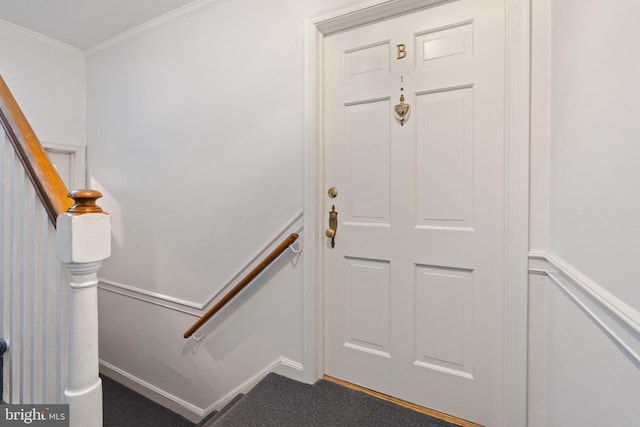 interior space featuring ornamental molding and carpet floors