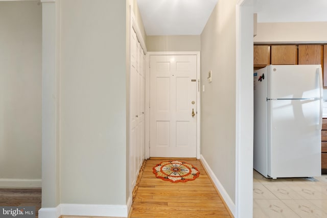 corridor with light hardwood / wood-style flooring