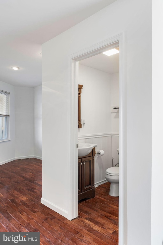 bathroom featuring wood-type flooring and toilet