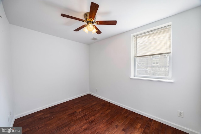 spare room featuring dark hardwood / wood-style floors and ceiling fan