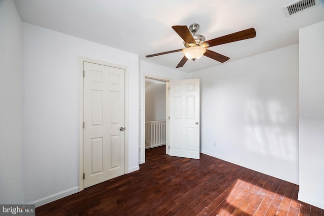 unfurnished bedroom with dark hardwood / wood-style floors and ceiling fan