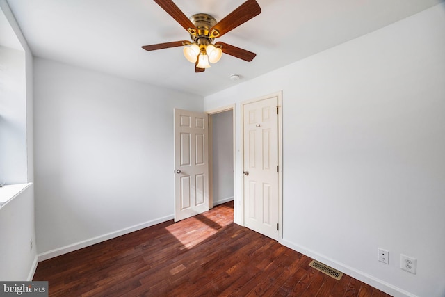 unfurnished bedroom with dark wood-type flooring and ceiling fan