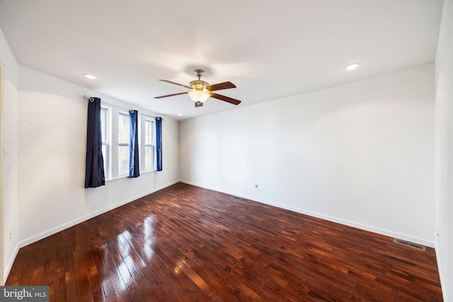 empty room featuring dark hardwood / wood-style floors and ceiling fan