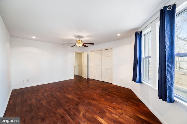 unfurnished bedroom featuring ceiling fan and dark hardwood / wood-style flooring