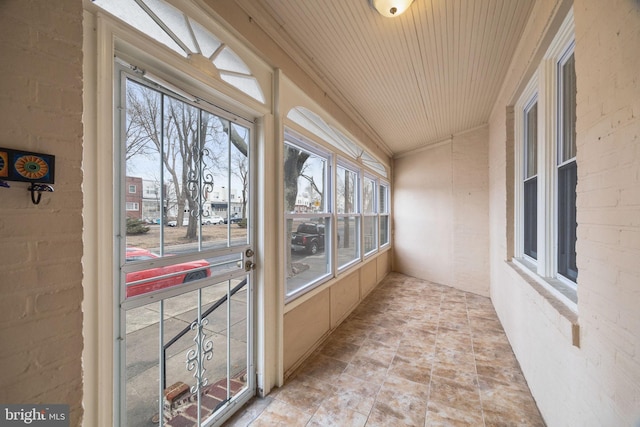 unfurnished sunroom featuring wooden ceiling