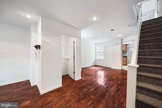 unfurnished living room featuring dark hardwood / wood-style floors