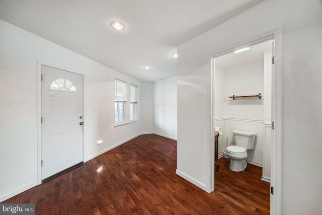 foyer entrance featuring dark wood-type flooring