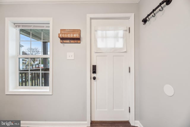 doorway featuring baseboards