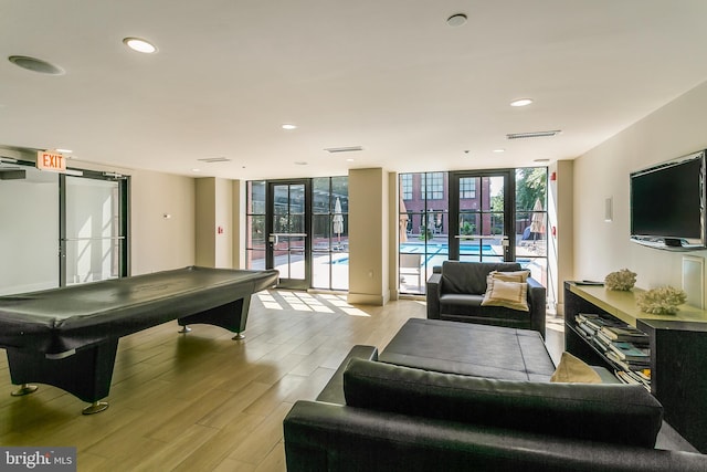 game room with floor to ceiling windows, plenty of natural light, light wood-type flooring, and billiards