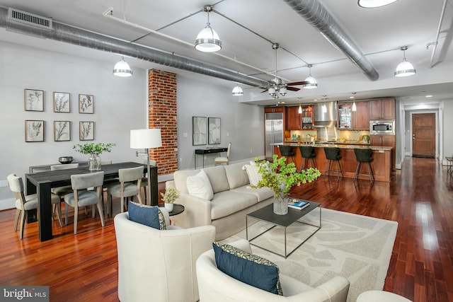 living room featuring ceiling fan and dark hardwood / wood-style floors