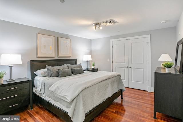 bedroom featuring wood-type flooring and a closet