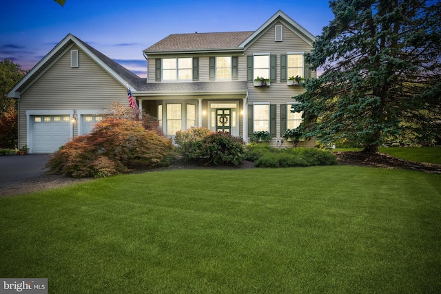 view of front property featuring a yard and a garage