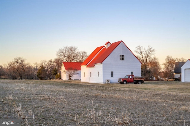 property exterior at dusk featuring metal roof