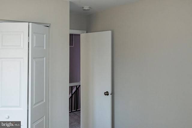 unfurnished bedroom with a closet and carpet flooring