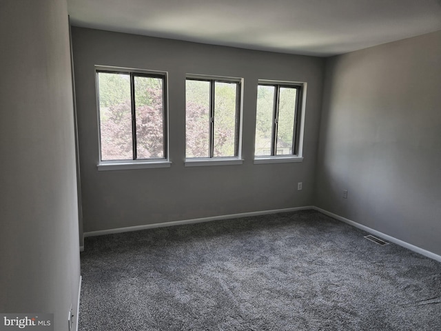 carpeted empty room with baseboards and visible vents