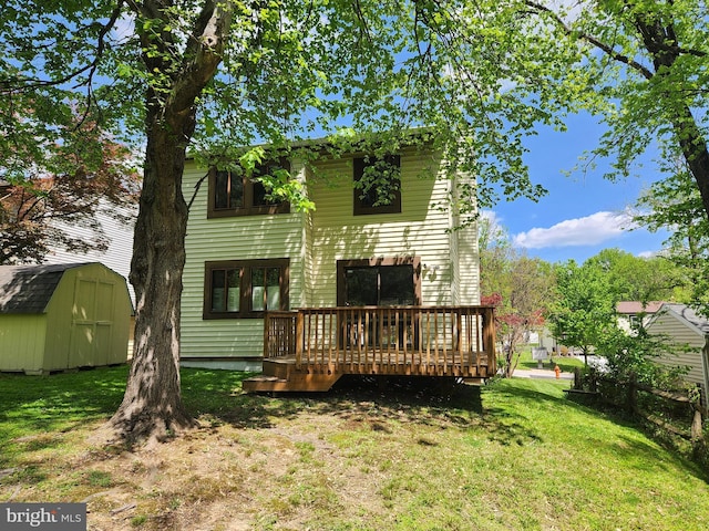 back of property featuring a lawn, an outbuilding, a wooden deck, and a shed