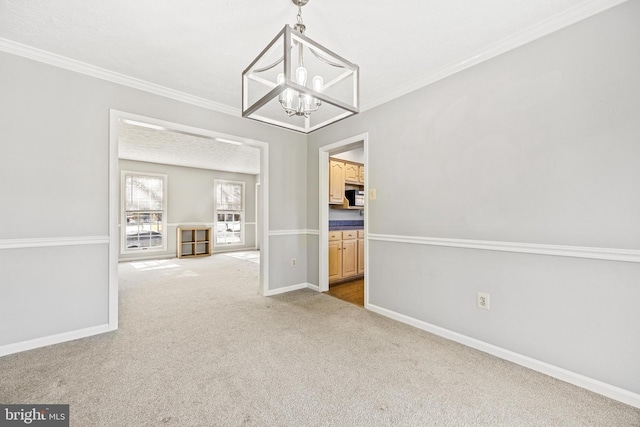 unfurnished dining area featuring light carpet, ornamental molding, and a chandelier