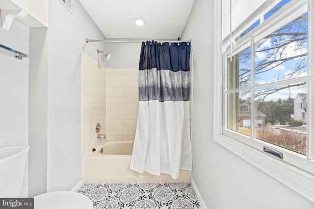 bathroom with shower / tub combo with curtain, toilet, and tile patterned flooring