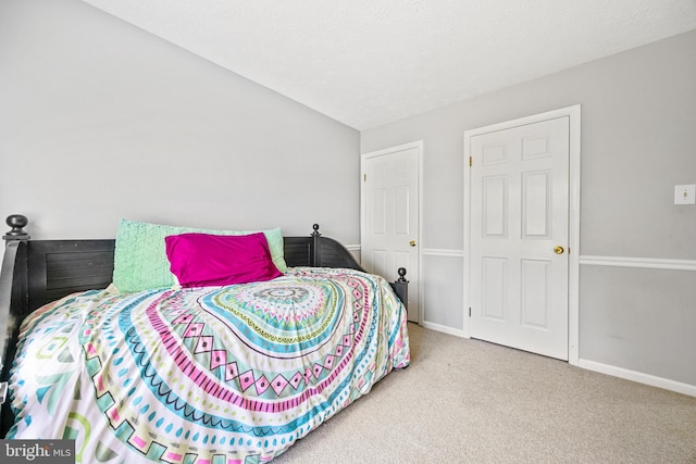 carpeted bedroom featuring a textured ceiling