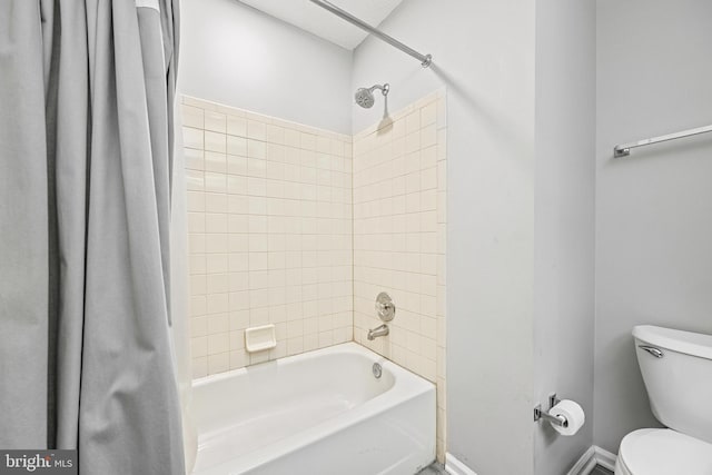 bathroom featuring shower / bathtub combination with curtain and toilet