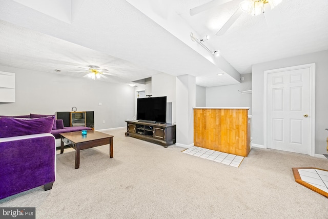 carpeted living room with a textured ceiling and ceiling fan