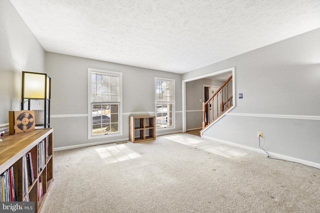 living room featuring carpet floors and a textured ceiling