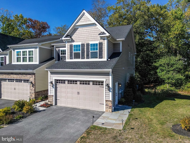 craftsman-style house featuring a garage and a front lawn