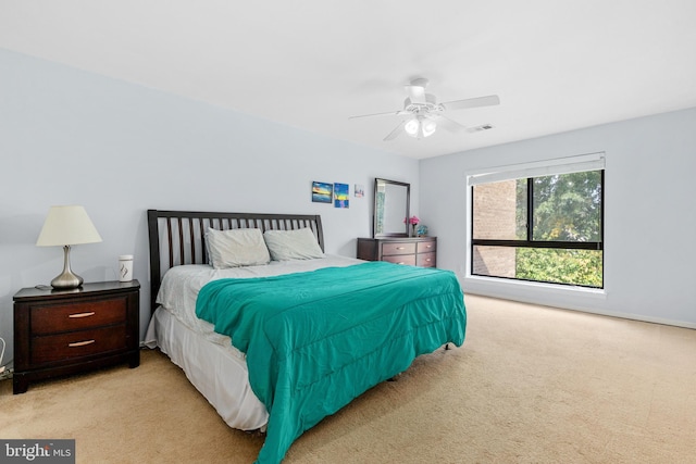 bedroom with ceiling fan and light colored carpet