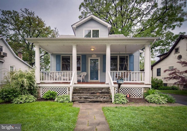 bungalow-style house featuring a front yard and covered porch