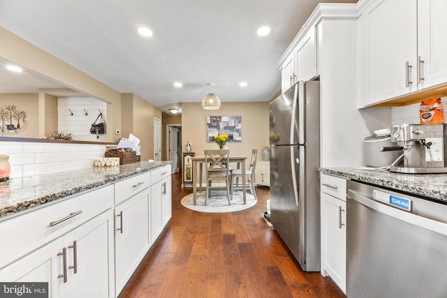 kitchen featuring white cabinets, dark wood-style floors, appliances with stainless steel finishes, backsplash, and recessed lighting