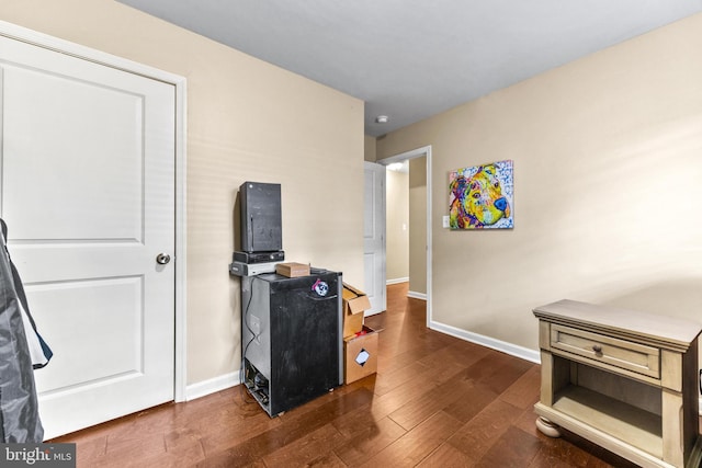 interior space featuring dark wood-type flooring and baseboards