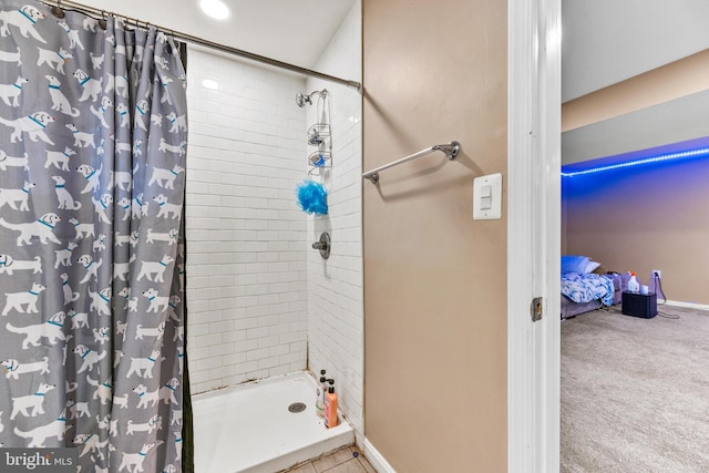 full bathroom featuring a stall shower and baseboards