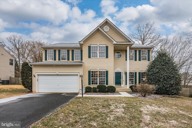 view of front of house featuring aphalt driveway, a front yard, and an attached garage