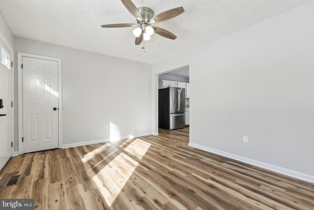 unfurnished room with ceiling fan and wood-type flooring