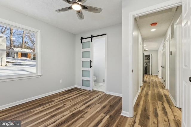 interior space with dark wood-type flooring and a barn door