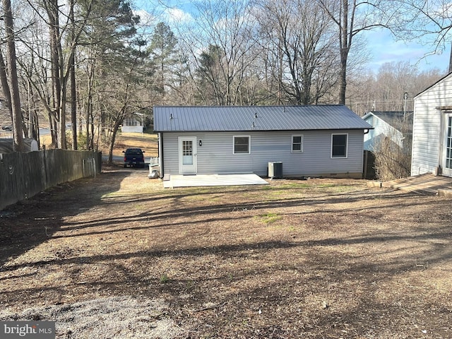 rear view of property featuring cooling unit and a patio area