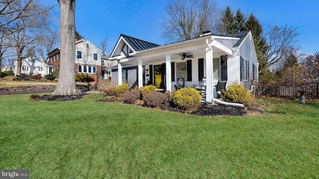 view of front of home with a porch, a front yard, and ceiling fan